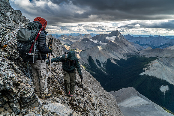 Carefully sticking close together to avoid rock fall incidents - a key factor to traveling safely down mountains in the Rockies!