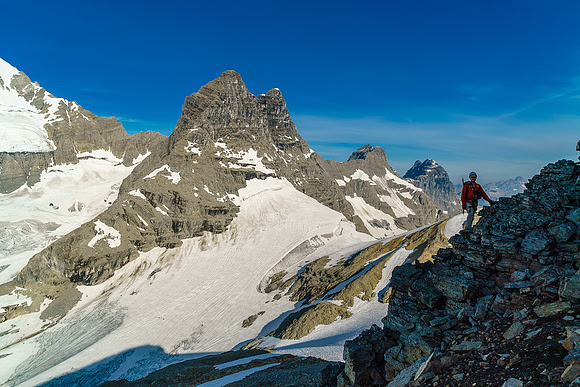 Ben climbs above the snow with the impressive summits of Prince Henry, Prince John and Queen Mary in the background
