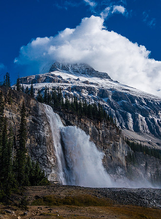 An amazing scene of power and beauty. Emperor Falls with the lower part of Robson's Emperor Ridge towering in the swirling clouds above.