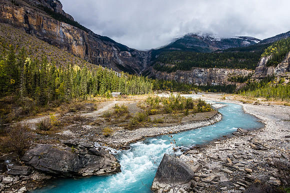 View of the Whitehorn Ranger cabin and the start of the Valley of a Thousand Falls from the pedestrian cable bridge across the Robson River