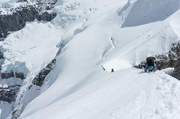 Raf's view of the two teams carefully down climbing the snow arete from the summit of Twins Tower.