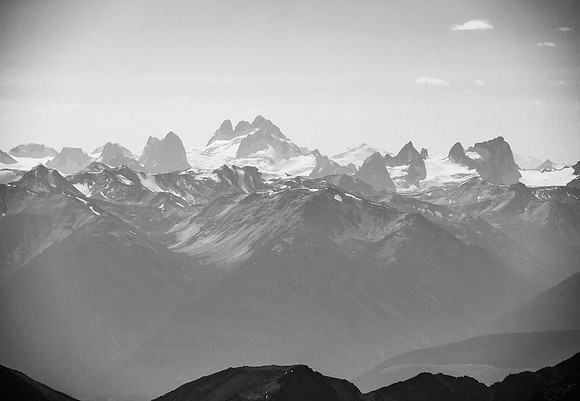 The Bugaboos are visible through haze to the west including the Howser Spires, Bugaboo Spire and Snowpatch Spire.