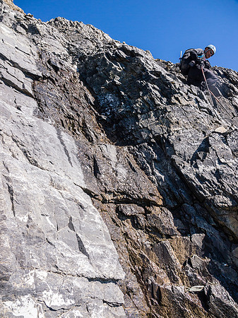 Carefully down climbing near the crux.