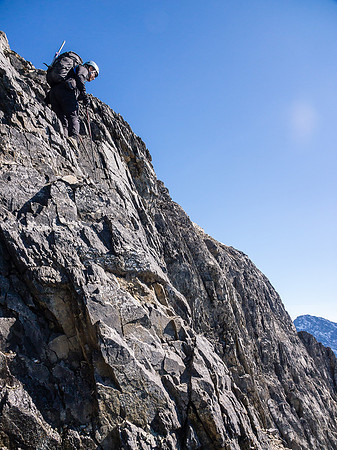 Carefully down climbing near the crux.