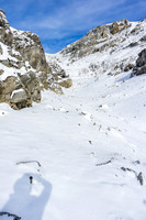 Through the ledges, the route is obvious again - the slopes to the col and summit ridge are just out of sight on the left.