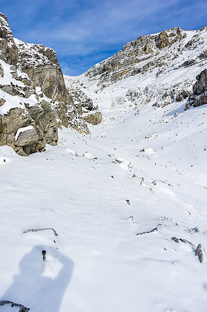 Through the ledges, the route is obvious again - the slopes to the col and summit ridge are just out of sight on the left.