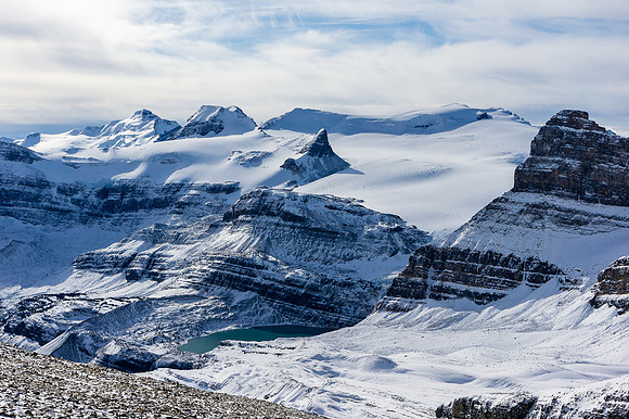 Incredible lighting and views over an unfrozen Iceberg Lake (feeds Bow Falls) towards Portal, Gordon, St. Nicholas, Olive and Balfour
