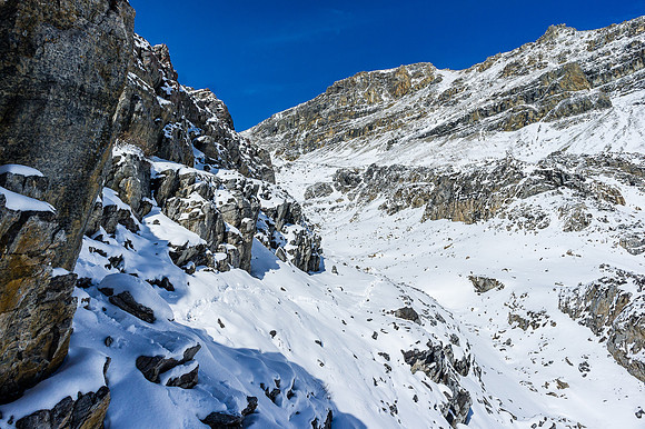 Looking back along the ledge route to the col and summit at upper right.