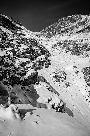 Looking back along the ledge route to the col and summit at upper right.