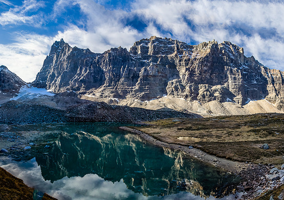 Mount Biddle reflects in Opabin Lake. Opabin Pass at far left.