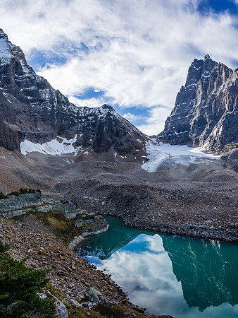 Hungabee (L) and Biddle (R) reflect in the green waters of Opabin Lake.