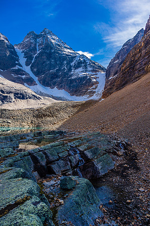 Water flows from Lake Oesa to Lefroy Lake with Mount Ringrose looming many thousands of feet above.