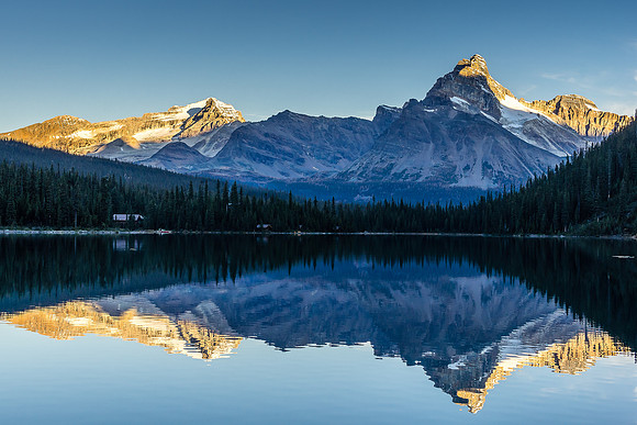 Mount Stephen (L) and Cathedral (R) reflect in a calm Lake O'Hara.