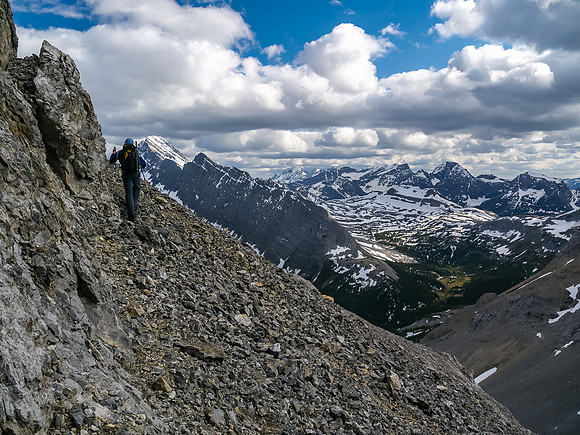 Some exposure and loose scree before turning climber's left up a steep scree gully.