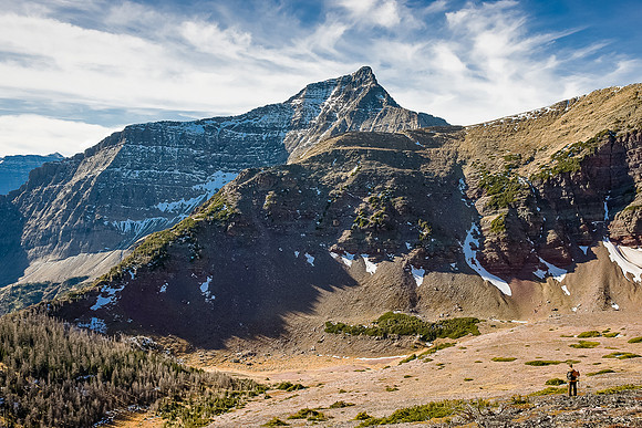 Wietse climbs above the hanging valley with Mount Alderson in the background.