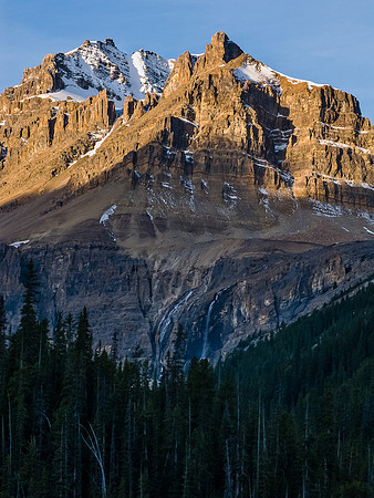 Gazing up at the very impressive north face of Peyto Peak with the dual Caldron Falls coming down below it.