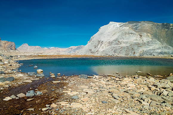 Looking across a small tarn towards Caldron's easy-but-long scree slog to the summit.