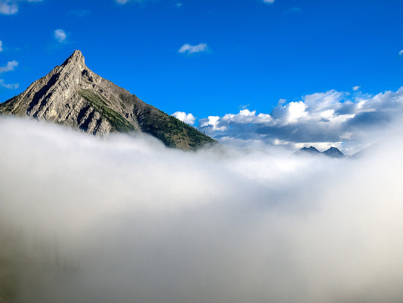 As we get higher we start hiking above the low cloud. This is looking back at a local outlier.