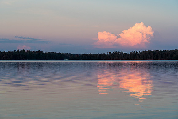 A distant thunderstorm reflects in Indian House Lake.
