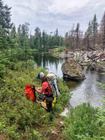 Portaging from Royd Lake to Kennedy Lake along Royd Creek.