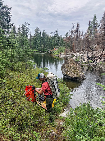 Portaging from Royd Lake to Kennedy Lake along Royd Creek.