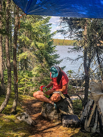 KC reads her book at the Haven Lake campsite.