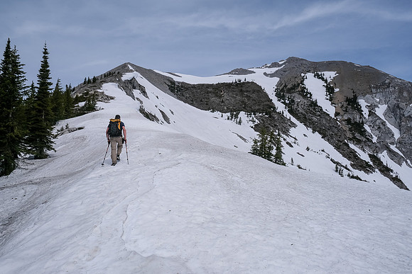 The summit ridge and the true summit (R) visible as we finish our snowy traverse.