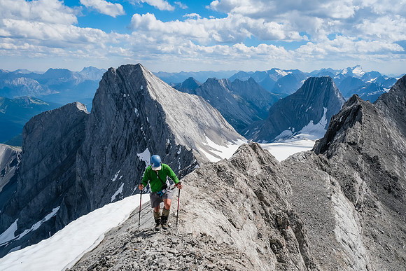 Grant traverses some exposed slabs with wicked views of Smith Dorrien behind him.