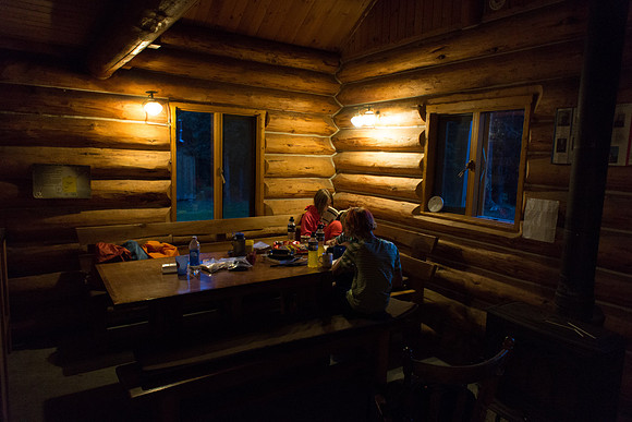 The Elk Lakes ACC Hut is cozy at night.