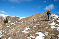 Wietse with the summit cairn (and flag) above.