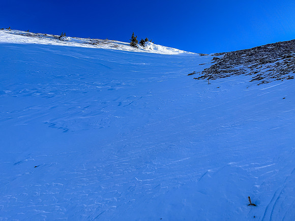 Bootpacking up the last of the skiable terrain.