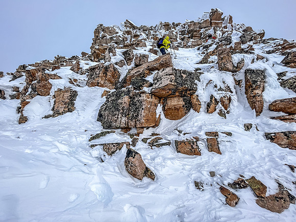 Ascending the crux outcrop on the south ridge.