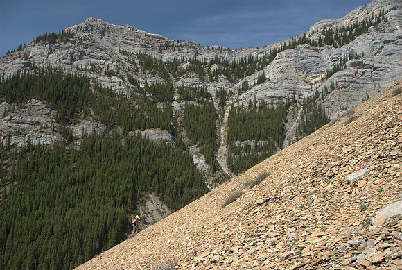Wietse scrambles up the loose orange shale slope.